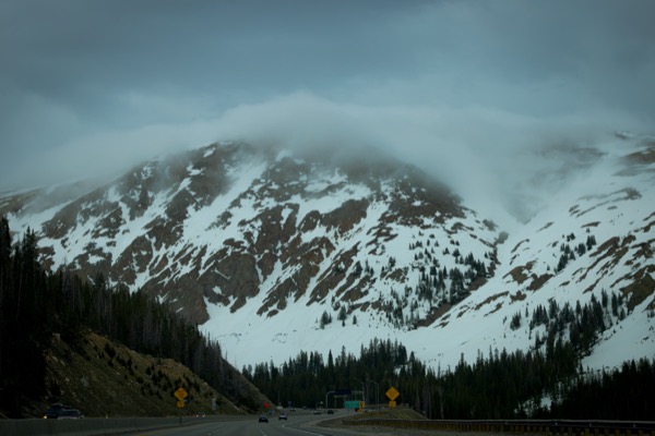 Colorado mountains near the Rocky Mountains region pop through thick low clouds